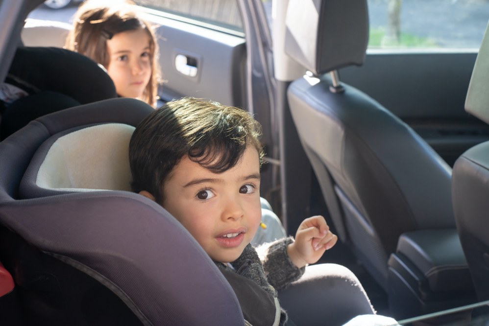two kids in car seat