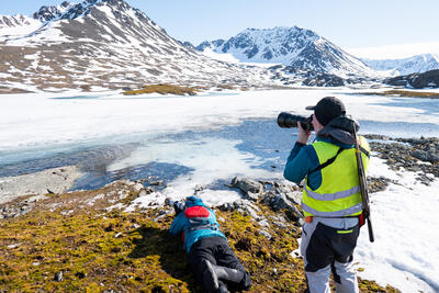 Expedition guides in the Arctic taking pictures