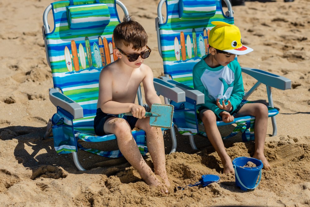 boys in deckchairs on beach holiday in the Med