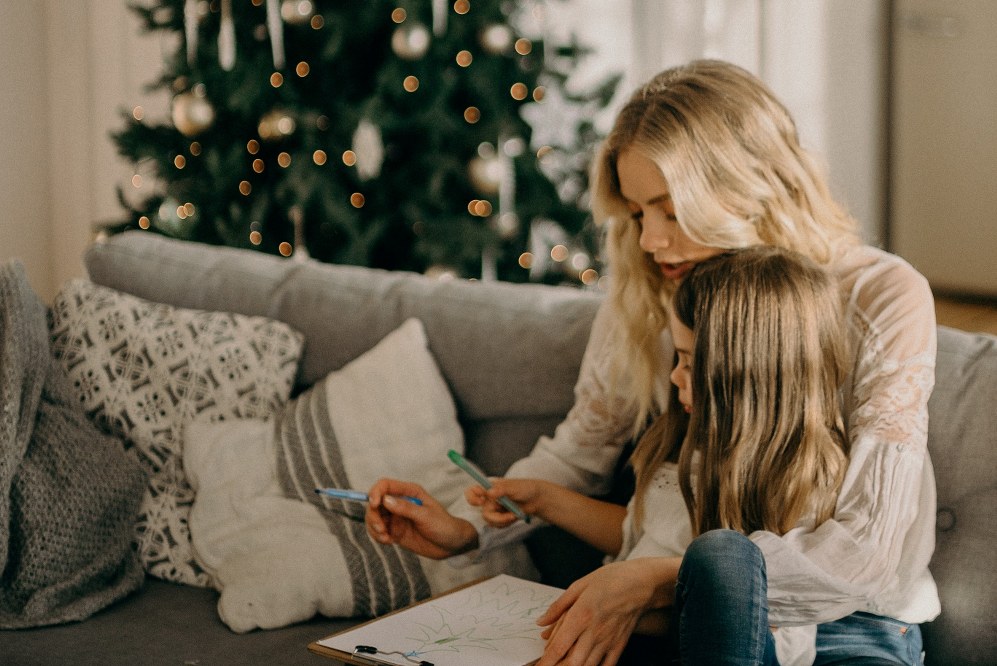 single mum and daughter drawing xmas tree