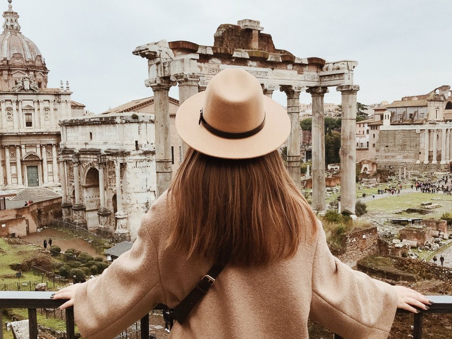 solo traveller looking at Roman ruins