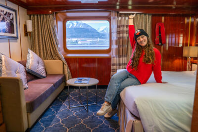 girl posing in cruise cabin on Sea Spirit cruise ship