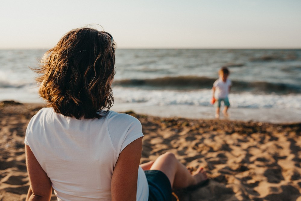 single mum on beach holiday with child